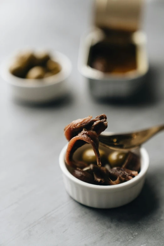 a spoon sticking out of a bowl full of food