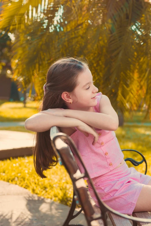 a  sitting on top of a wooden bench