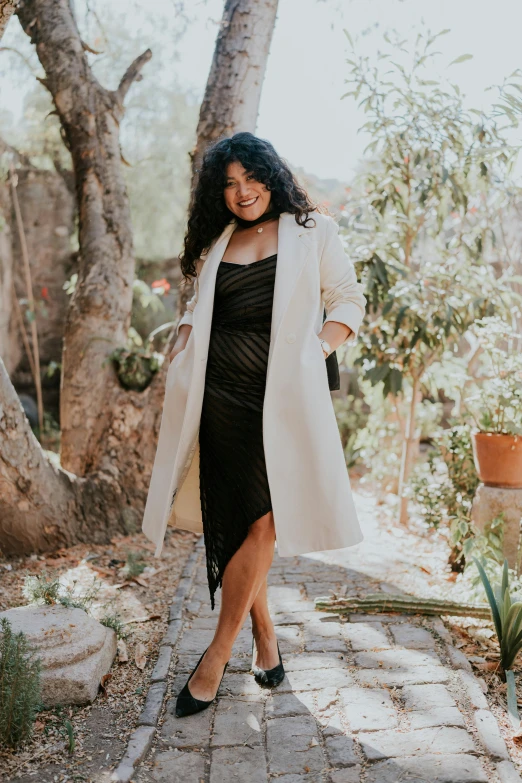 a smiling woman wearing black in a park