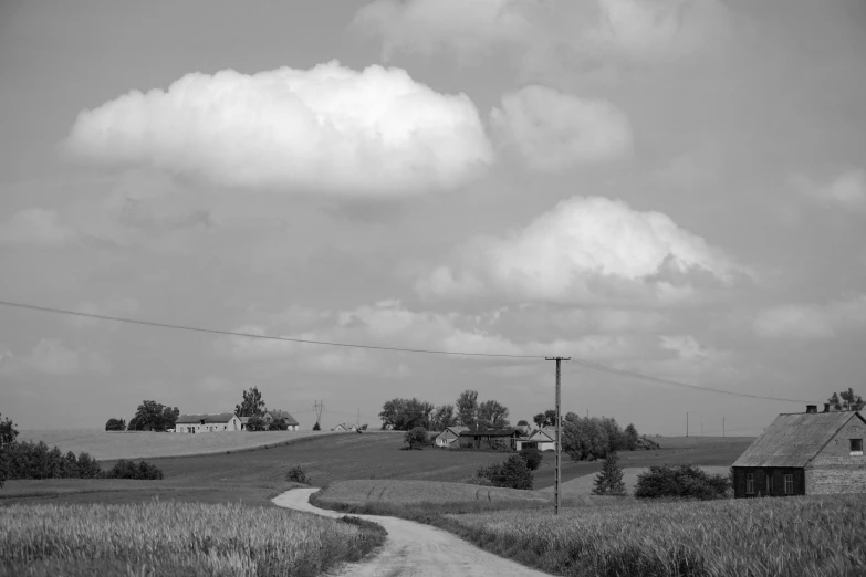 an old barn stands in the middle of a field