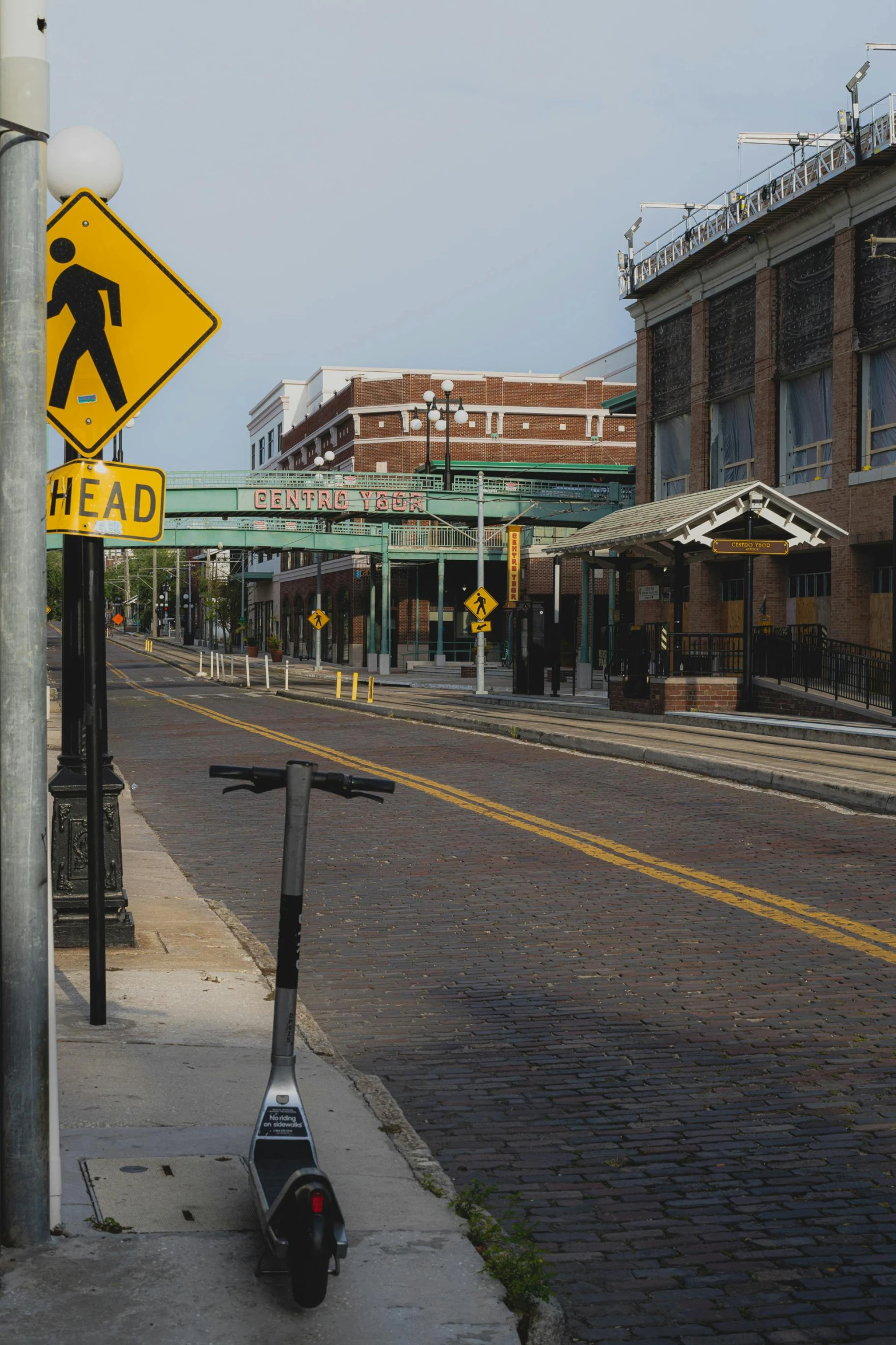 there is a pedestrian sign on the sidewalk