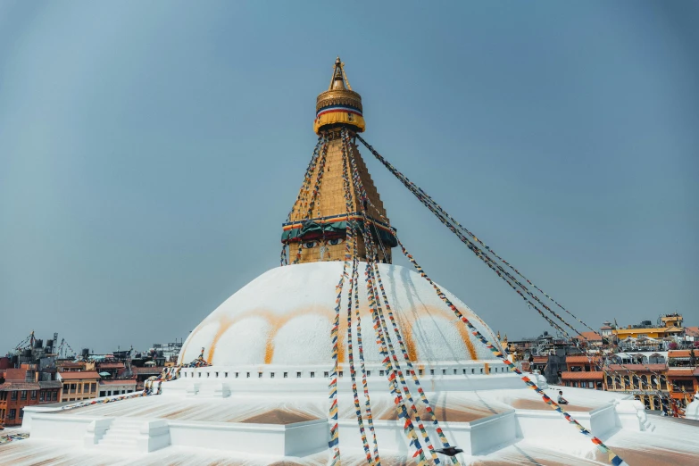 a large white building with gold trim and chains hanging from the top