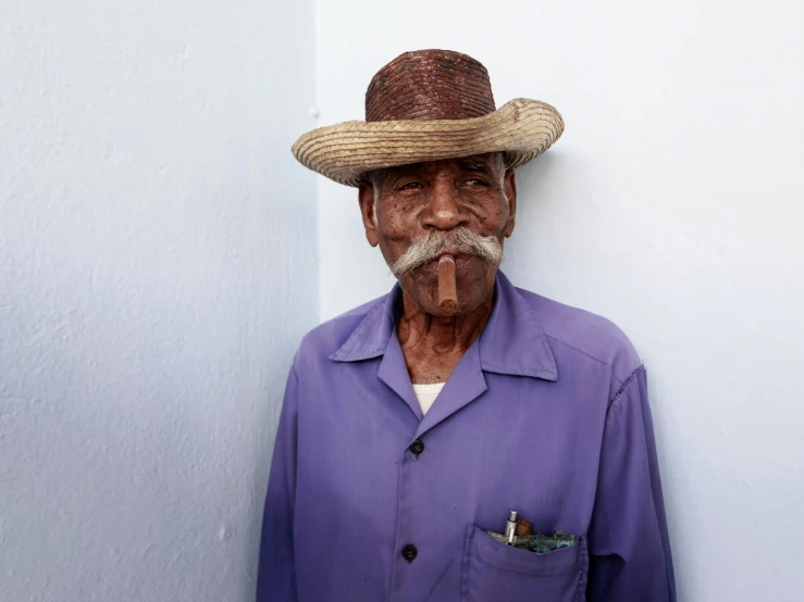 a man with a hat and a blue shirt