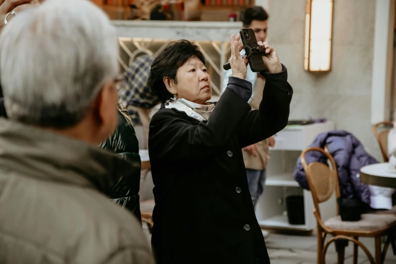 a woman is holding a camera in her hands