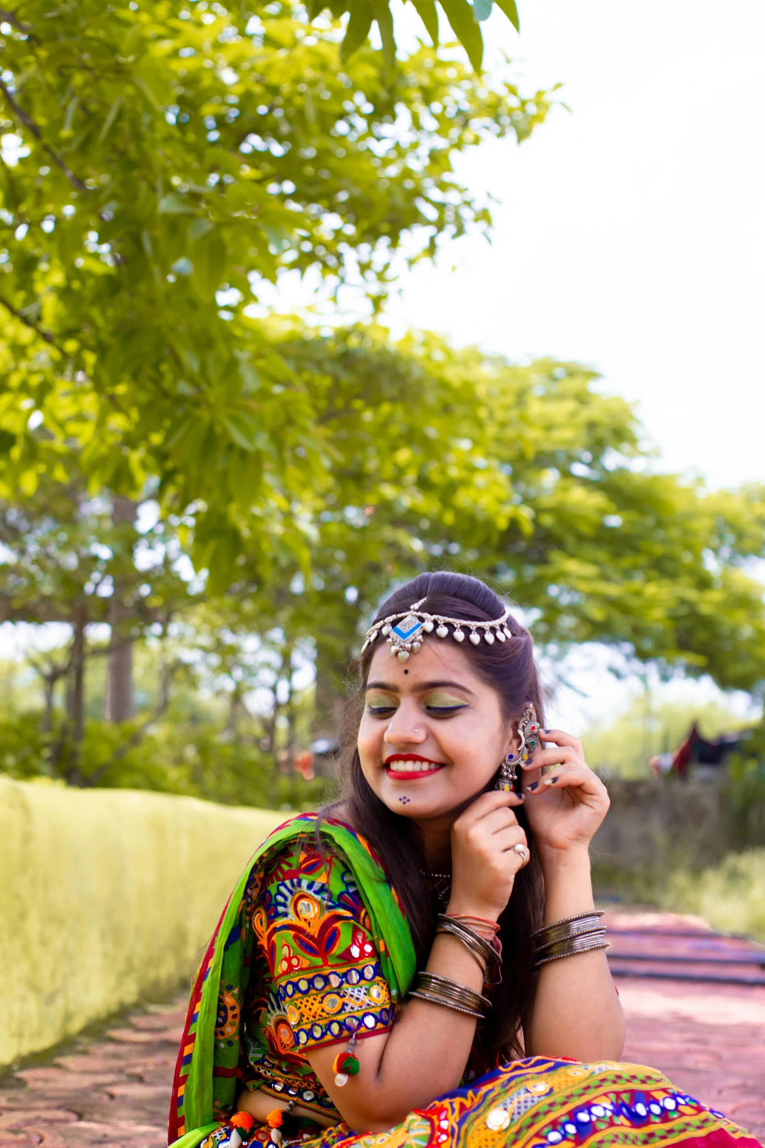 woman sitting down and posing with a smile on her face