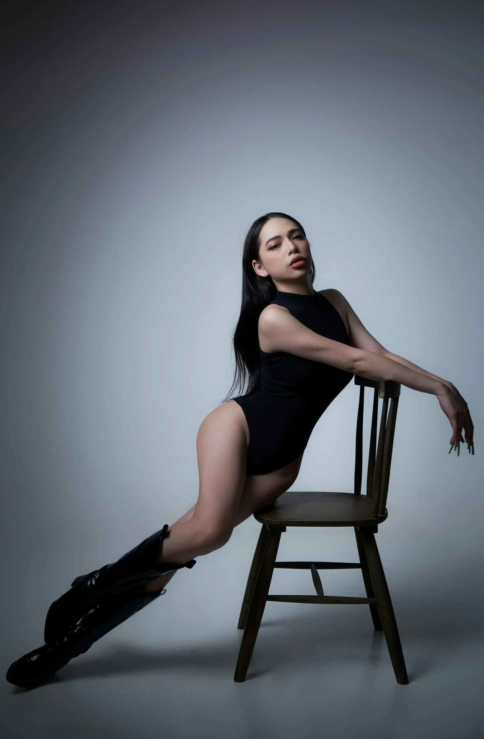 a woman posing on a chair in stockings