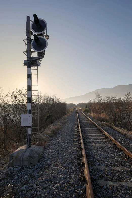 the traffic lights are on all sides of a railroad track