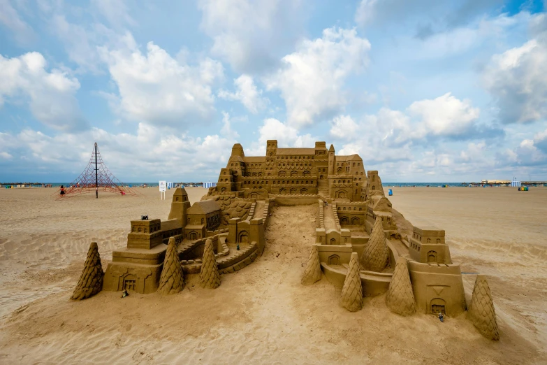 a sand castle sitting on top of a sandy beach