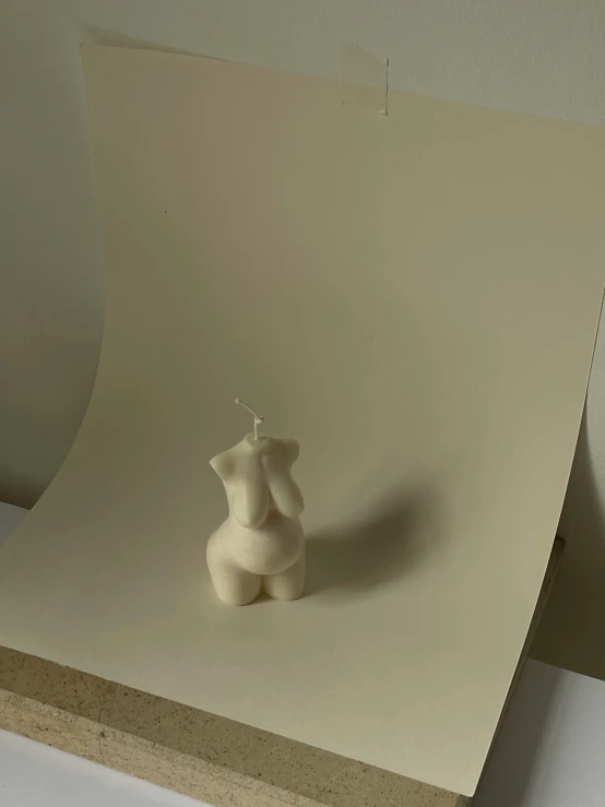 a white ceramic vase on top of a table