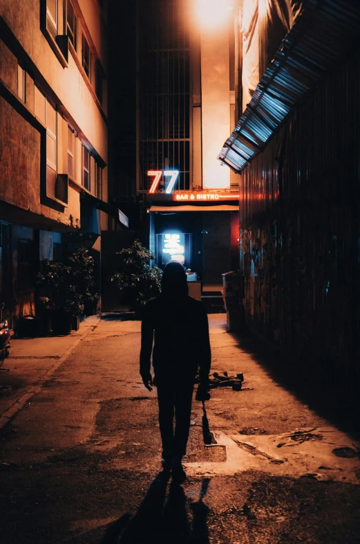 a person walks down the street at night