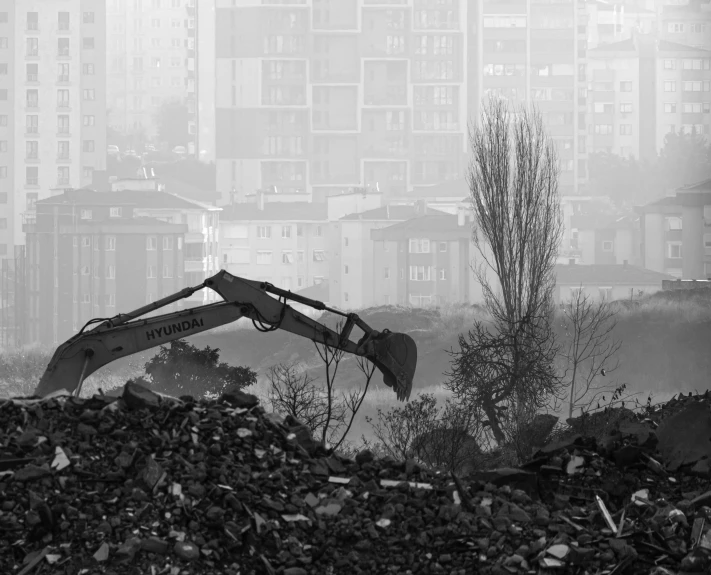 a digger digging through an area covered in rubble