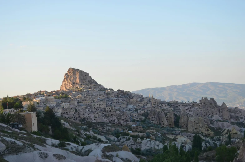 a rock formation that looks like town built into the side of a mountain