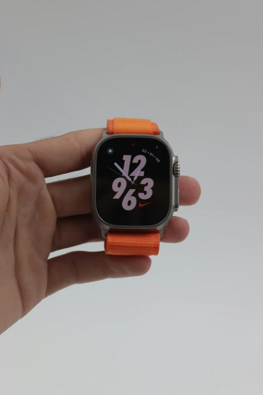 the apple watch has orange straps on it