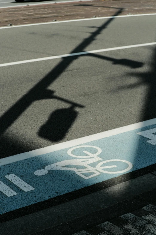 a crosswalk sign is painted with graffiti next to the street