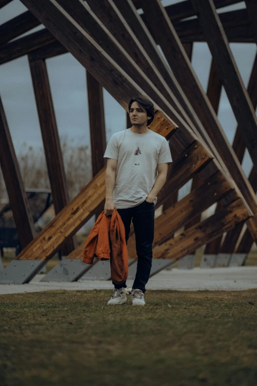 a man is standing in front of wooden structures