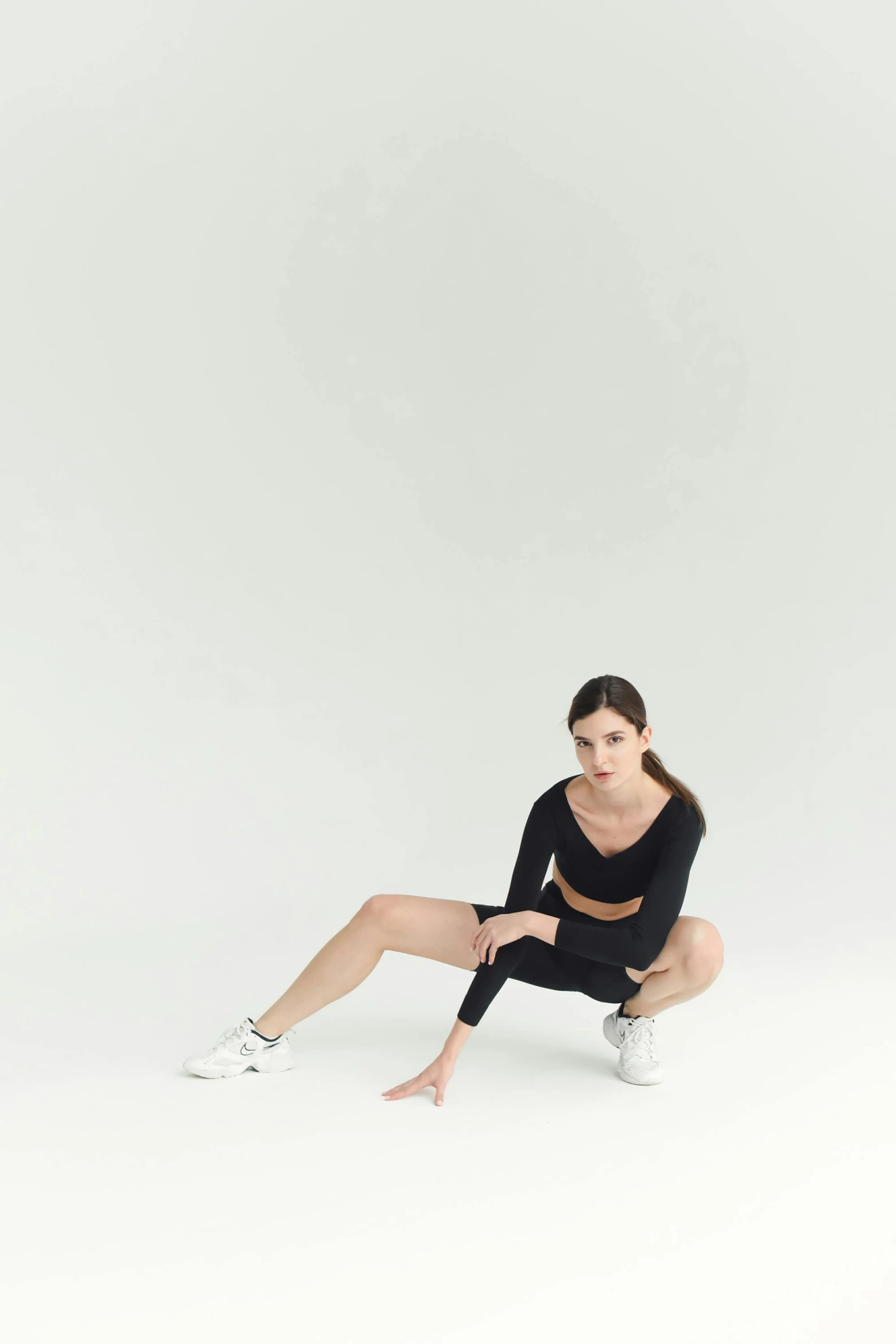 a young lady sitting down posing for the camera