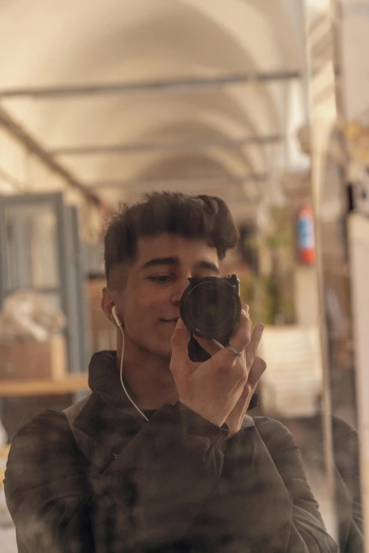 a young man is taking his selfie in the mirror