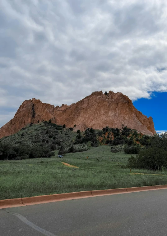 a big hill on the road with a blue sky