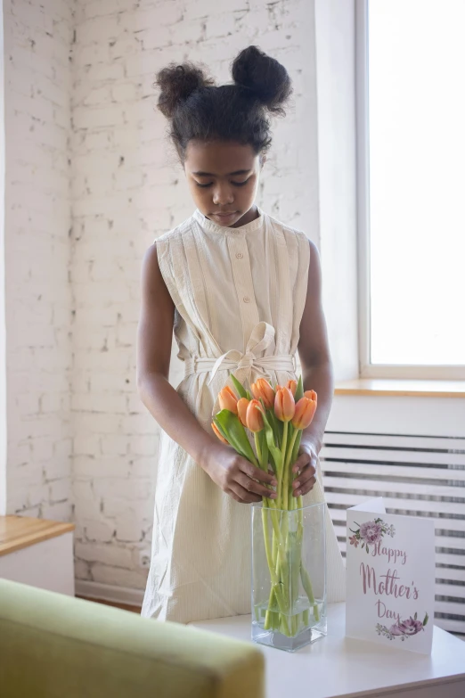 a  holding some flowers in a vase