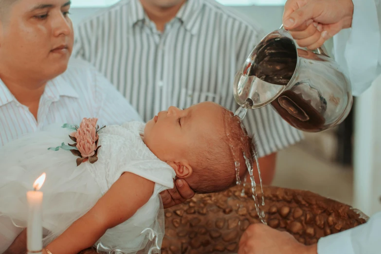 there is a small baby being held up to a woman