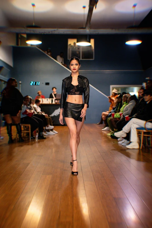 a model walking on a wooden floor in a showroom