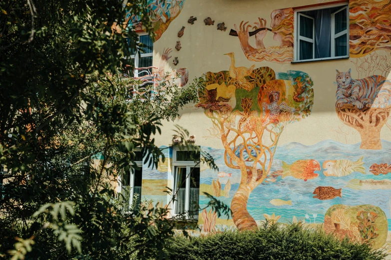 an interesting building painted with colorful murals on it