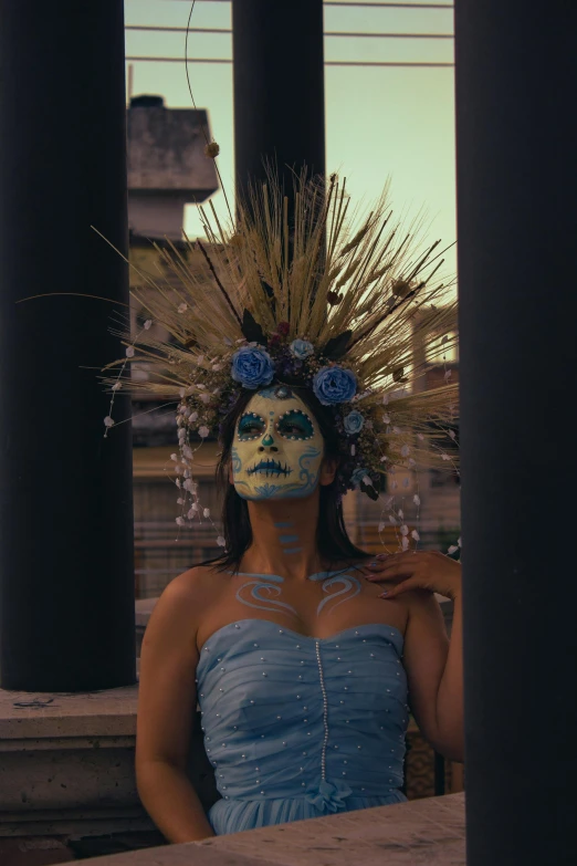 a woman with face paint standing outside at sunset