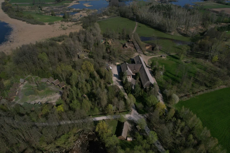 an aerial view of a house sitting in the middle of trees