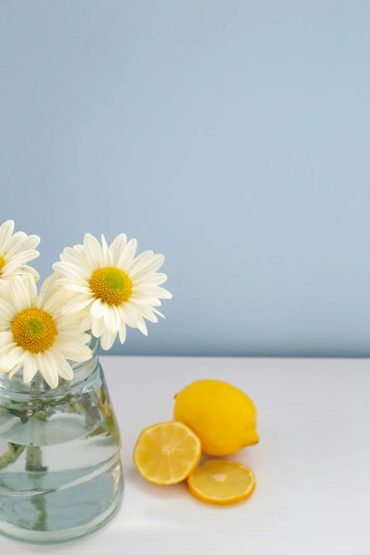 a close up of a vase on a table with flowers