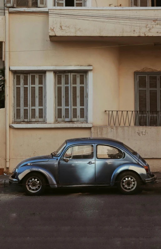 a silver car sitting in front of an old building