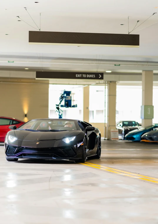 two luxury cars are parked in front of some stores