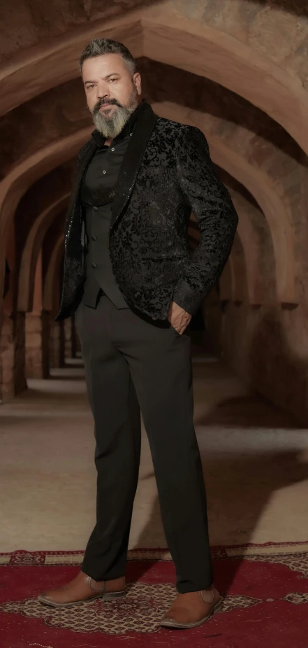 a person standing in an old tunnel wearing a black suit