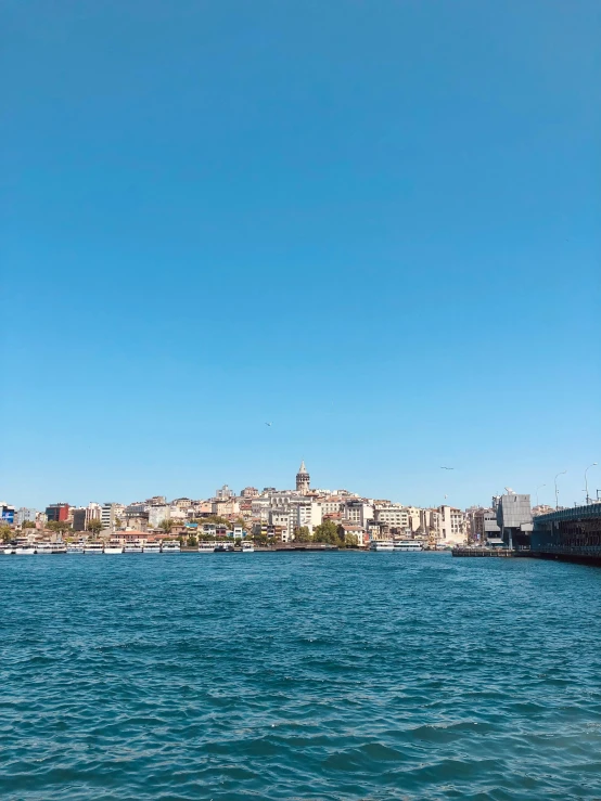 a body of water next to a city on a hill