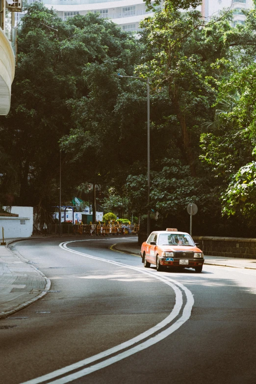 a street scene with focus on the car driving down the road