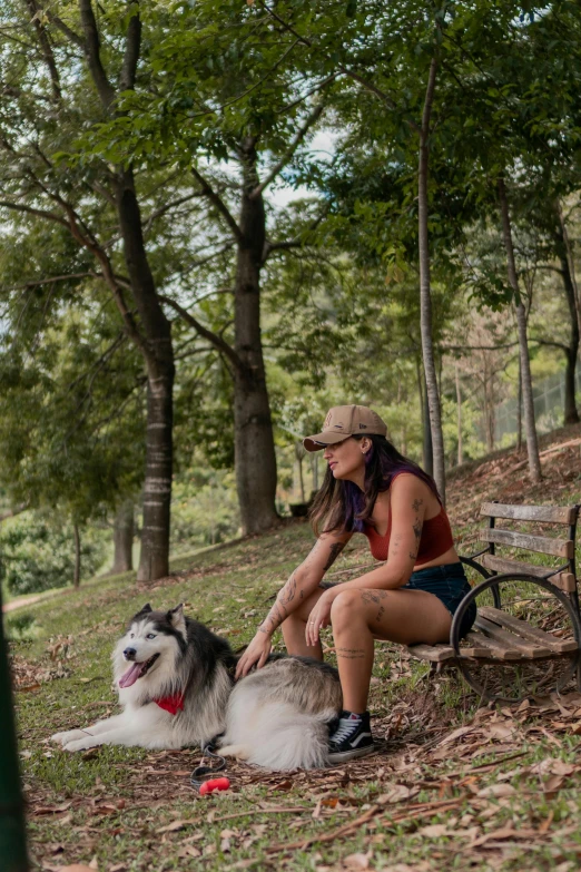 a woman petting a dog on the park