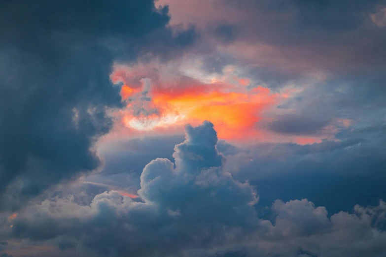 a bright orange and pink cloud at sunset