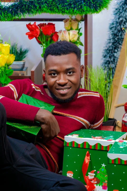 a man in red shirt holding up a christmas present