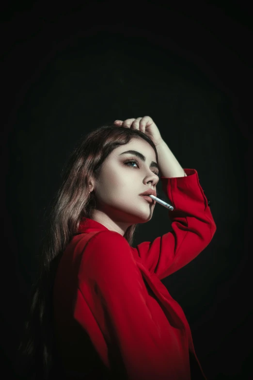 a young woman wearing a red shirt and smoking a cigarette