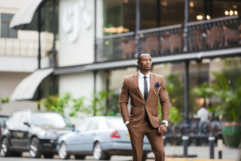 an african american man in suit walking down a street