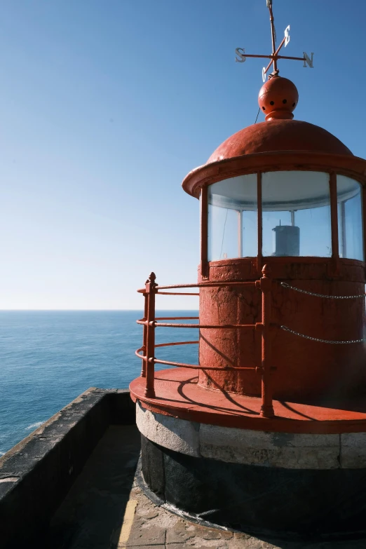 a light house with the ocean in the background