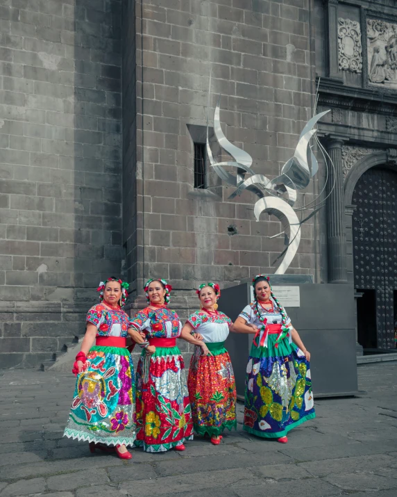 a group of women wearing colorful mexican dresses