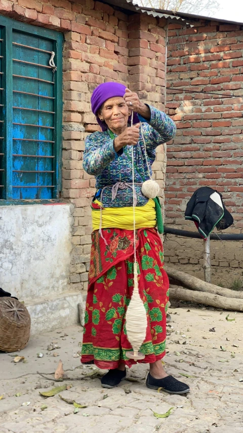 a woman that is holding a yarn ball