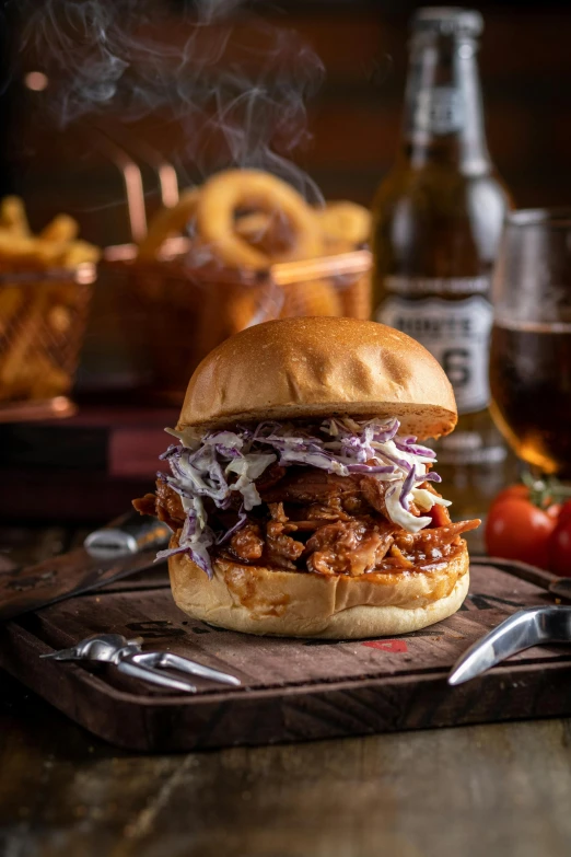 the bbq sandwich is served with a glass of wine and onion rings
