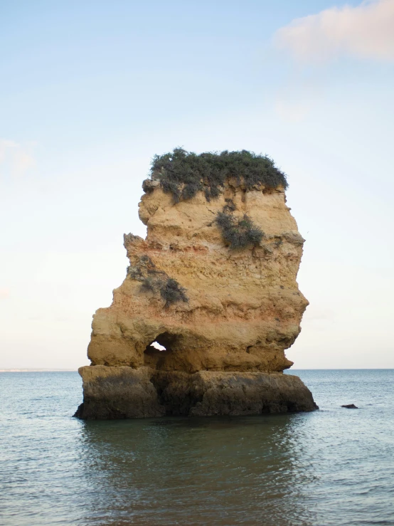 a rock in the middle of some water