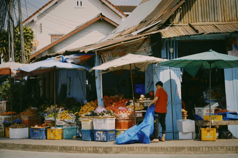 two people in red are shopping at an outdoor market