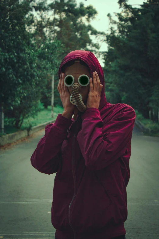 a person is covering their eyes with binoculars