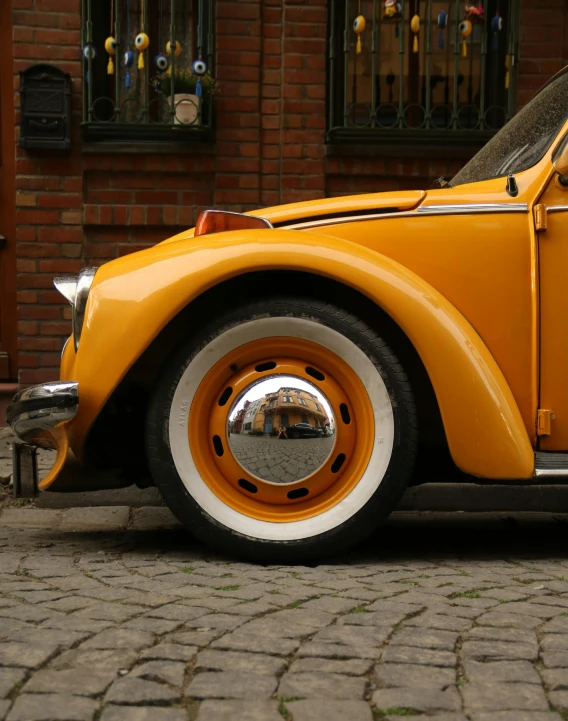 an orange and white car on a brick road