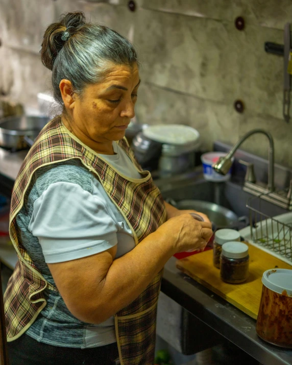 a woman in a kitchen washing dishes