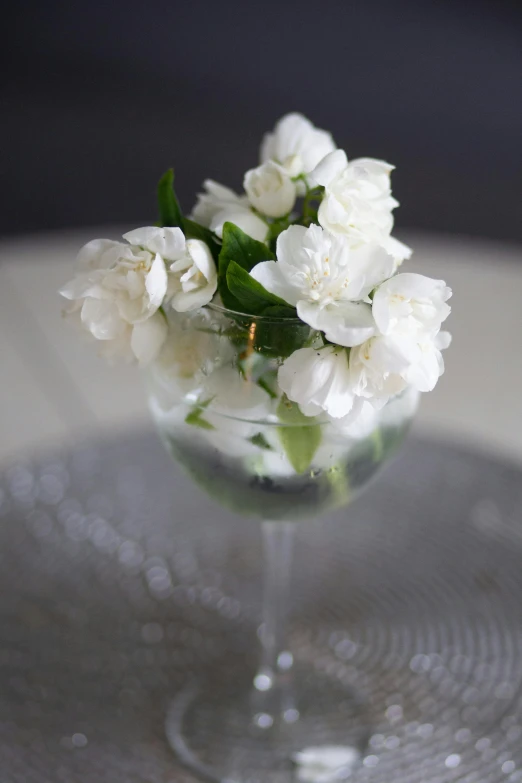 some white flowers sitting in a glass vase