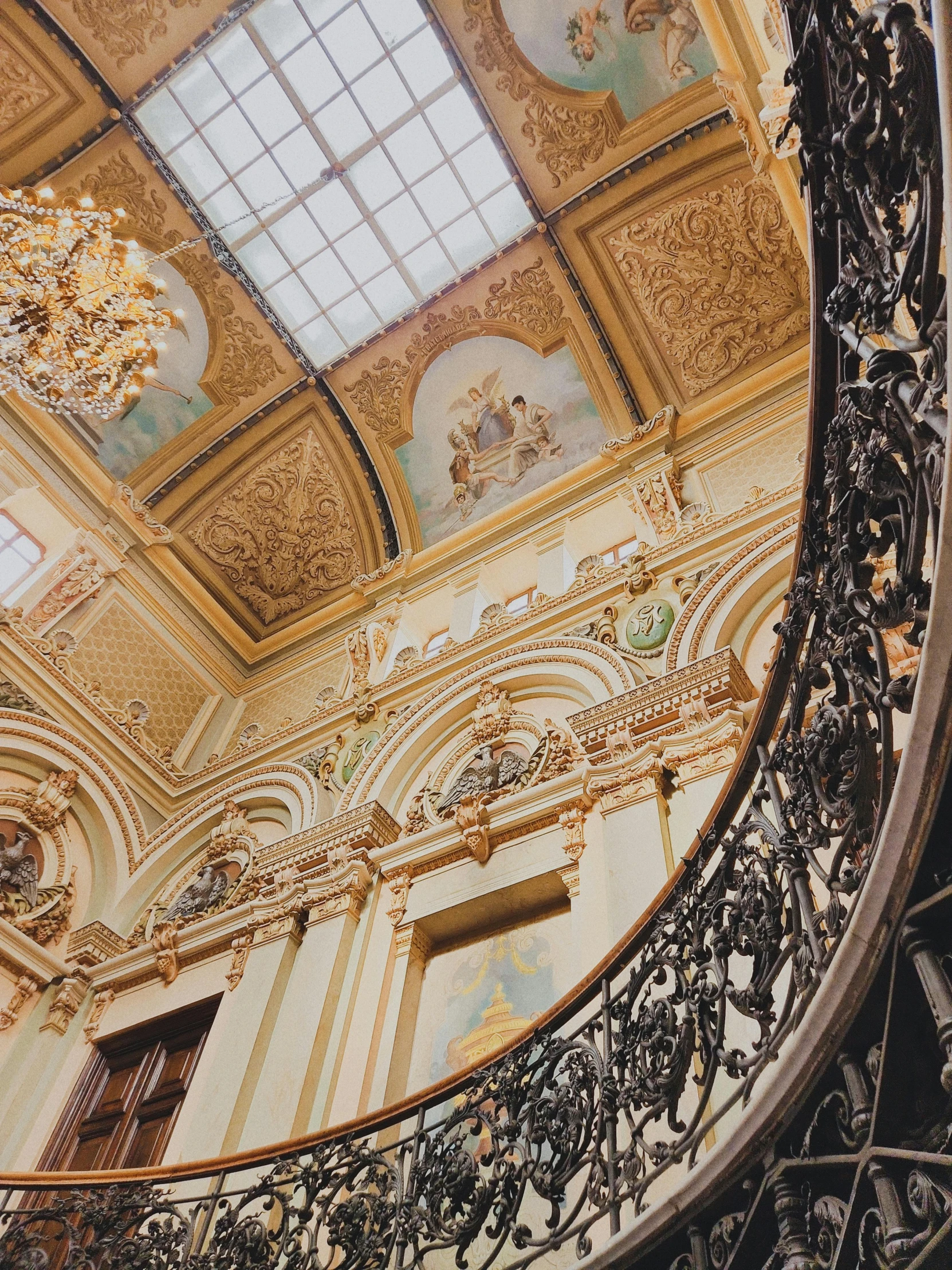 a round window sitting above a railing below a ceiling